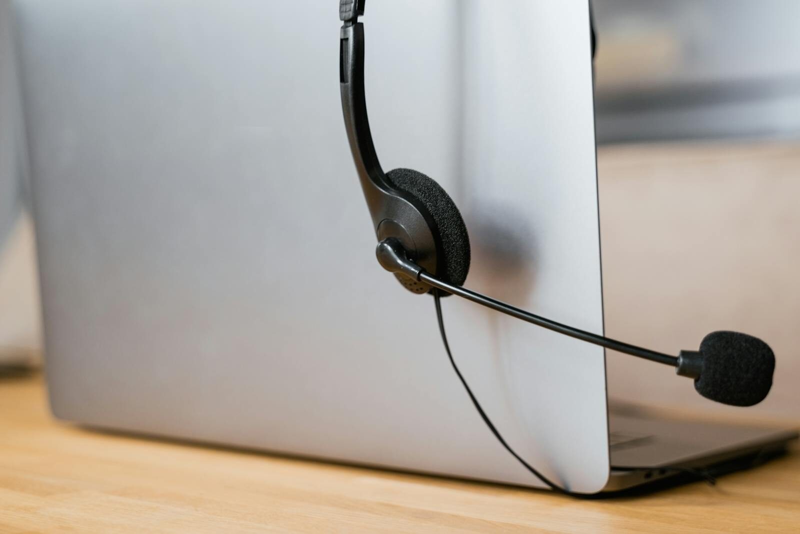 A laptop with a headset attached, ideal for virtual meetings or online customer support.